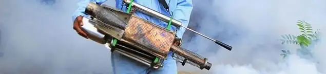Fumigation technician using a fogger for deep pest treatment in Albuquerque, NM