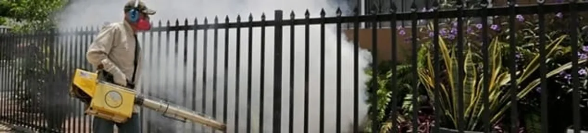 Mosquito control technician fogging a yard perimeter for mosquito reduction in Albuquerque, NM